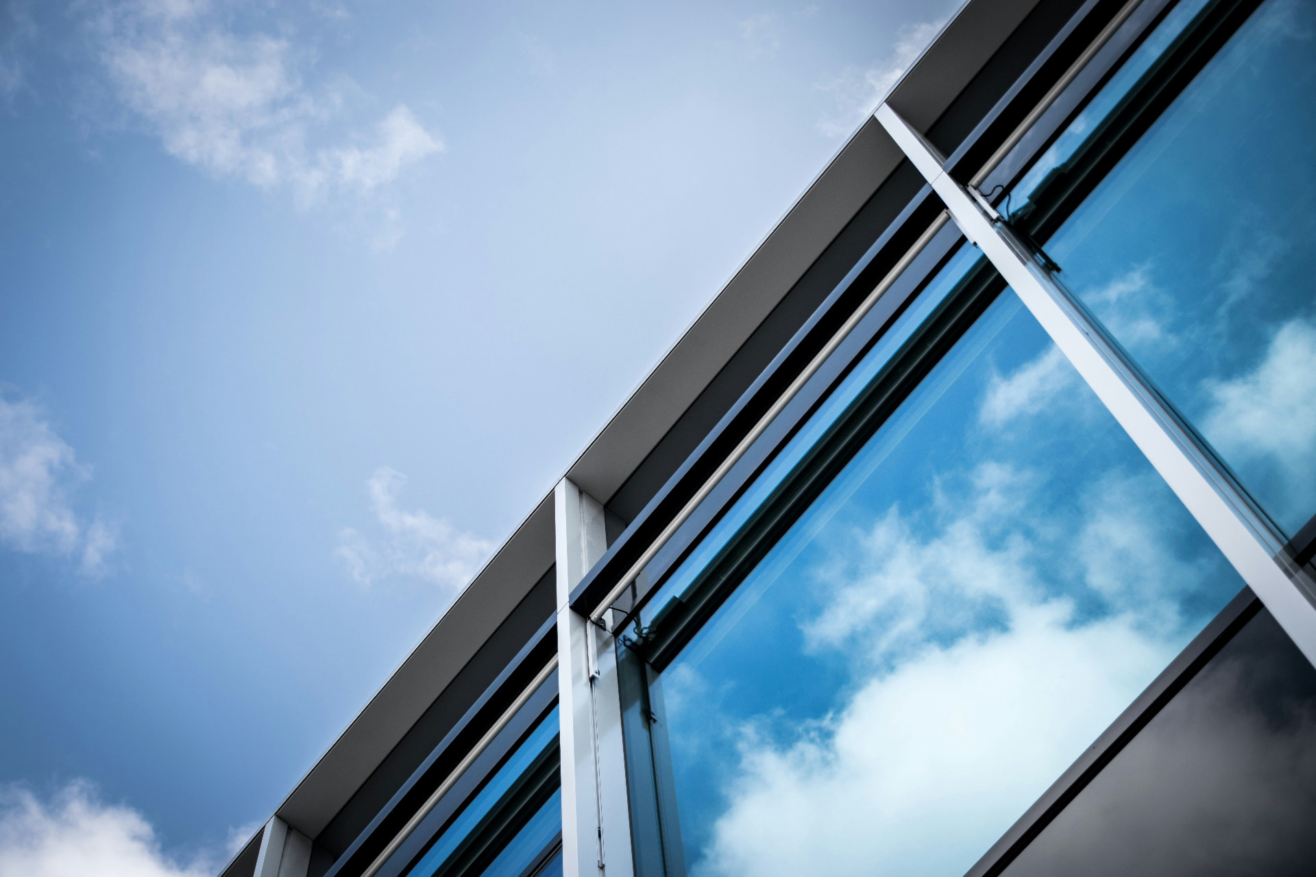 Crystal clear windows reflecting a bright blue sky