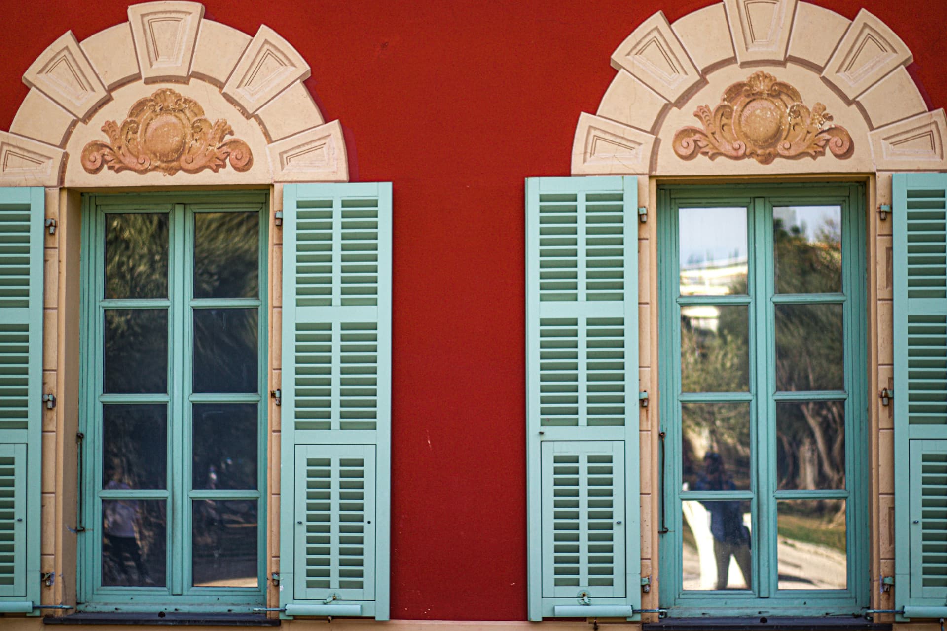 Pair of windows with shutters divided into small square panes