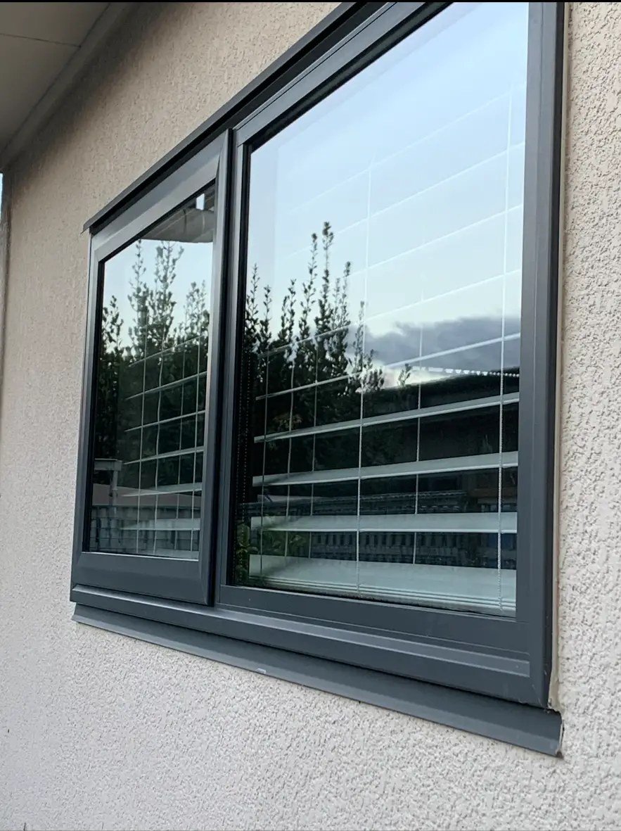 Sparkling double-pane windows reflecting a clear blue sky